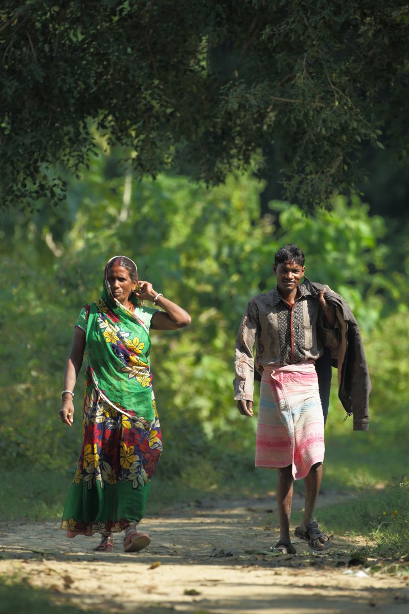 A couple walking down green corridor